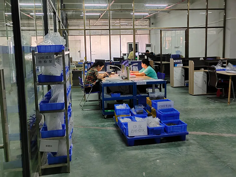 XiYu staff inspecting precision screw parts in the inspection area